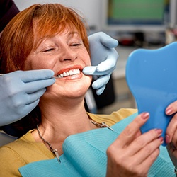 Patient reclined in treatment chair smiling